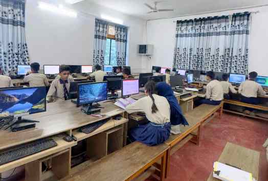 Senior school students working at computers in the AIPS computer lab